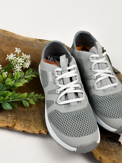 A gray women's athleisure sneaker with white laces.