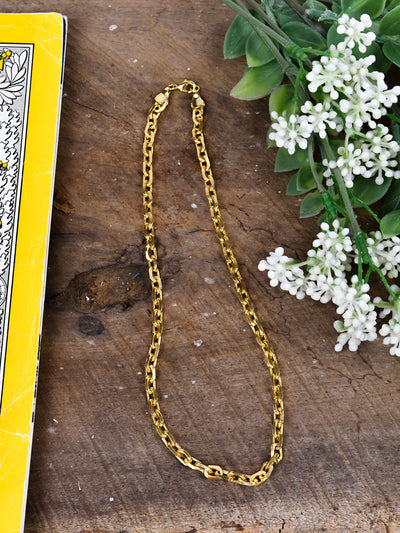 A short, gold chain necklace with tight links.