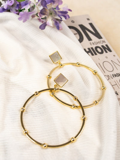 A gold beaded hoop with a pearlescent square at the top.