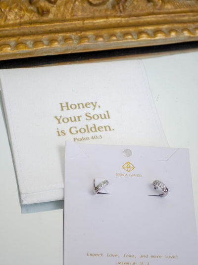 Silver dainty hoop earrings with diamond hardware. 