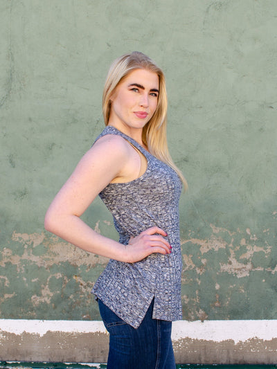 Model is wearing a stone grey textured fitted tank top. Top is worn with blue jeans. 