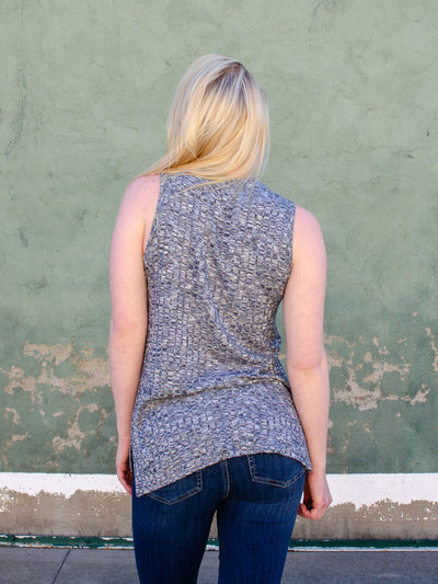 Model is wearing a stone grey textured fitted tank top. Top is worn with blue jeans. 