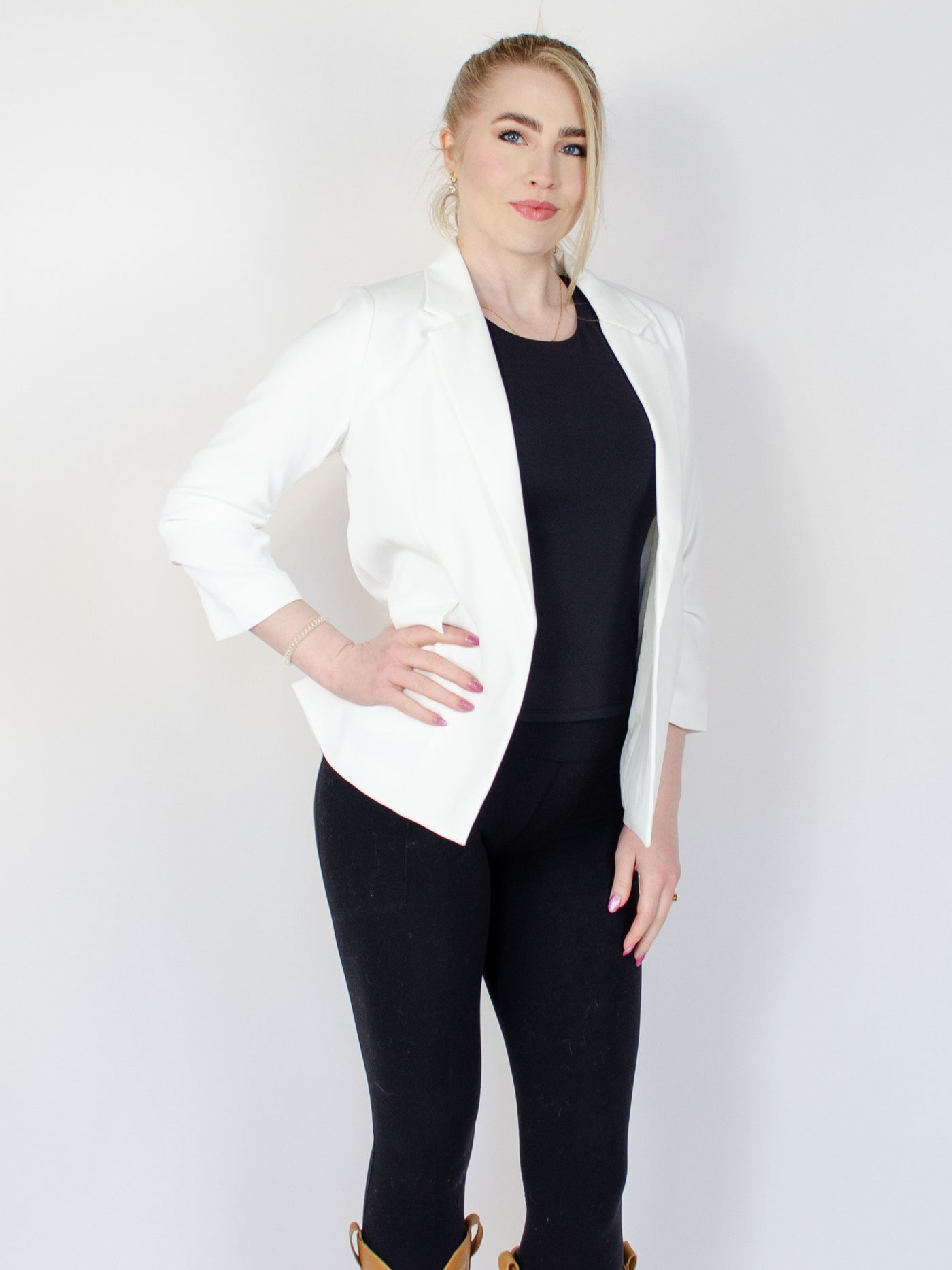 Model is wearing a white fitted blazer.