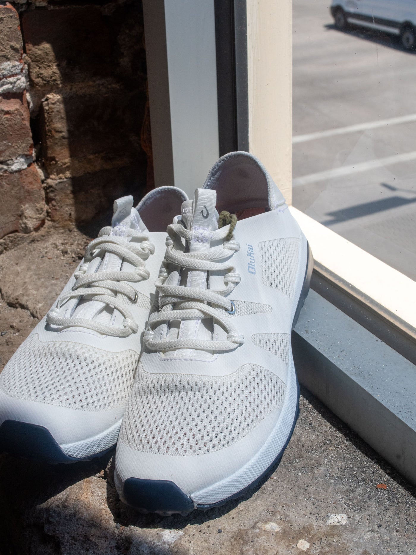 A white women's athleisure sneaker with white laces.