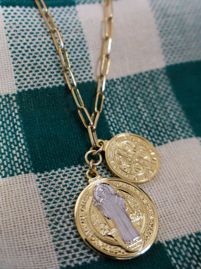 Double coin pendant necklace with saint benedict and a cross on a gold chain