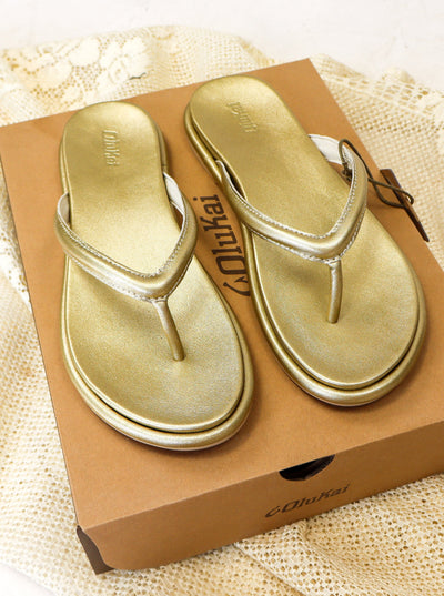 Gold shimmery flip flop sandals.