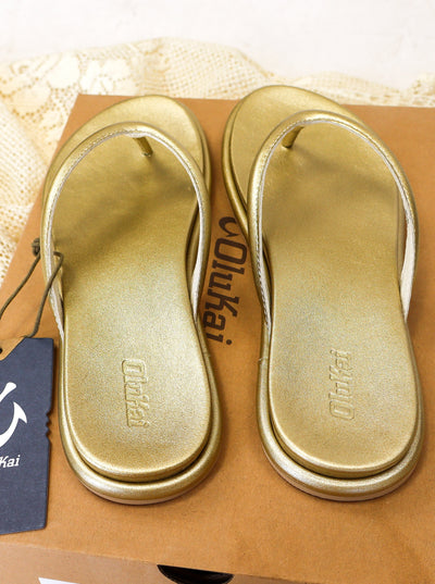 Gold shimmery flip flop sandals.