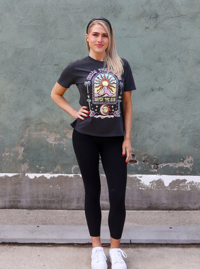 Charcoal grey graphic tee with black leggings.