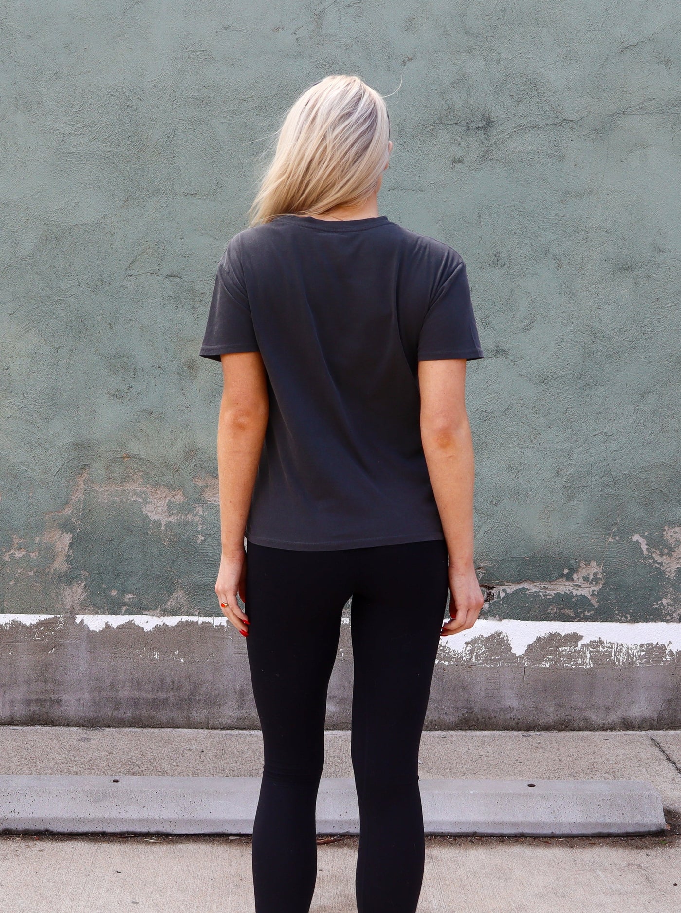 Charcoal grey graphic tee with black leggings.