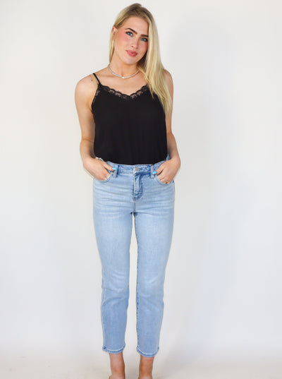 Model is wearing a light wash high rise denim jean: 28" Inseam, Hi-Rise 11-1/2", Set-in waistband with belt loops, 5-Pocket styling details, Zip-fly, and single logo button closure.