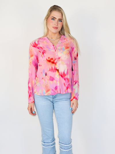 Model is wearing a long sleeve button up watercolor blouse: 26-1/4" HPS, Button-front closure, Button cuffs, Slightly sheer, Long sleeve, Liverpool exclusive print.