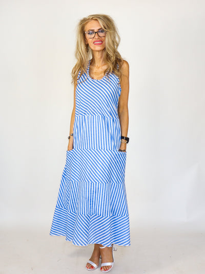 Nautical blue and white striped maxi dress with thick straps, pockets, and tiering details. 