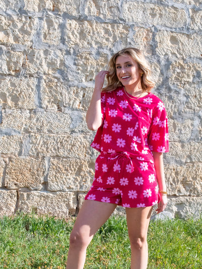 A model wearing a pink floral jacquard French Terry set. She has mini shorts and matching shirt in it on.