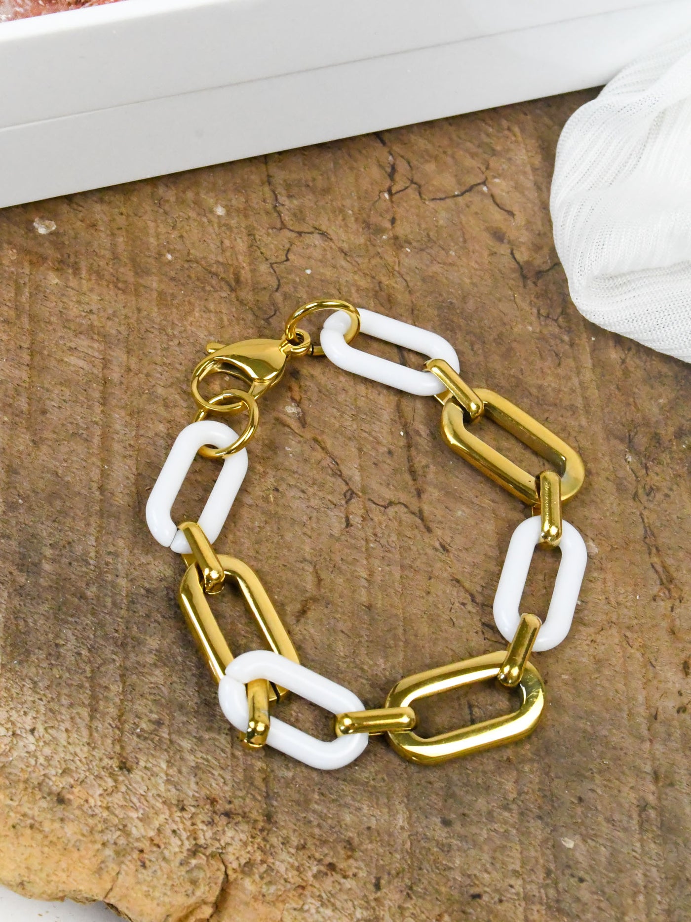A gold and acrylic link bracelet.