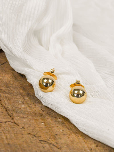 A gold bead stud earring.