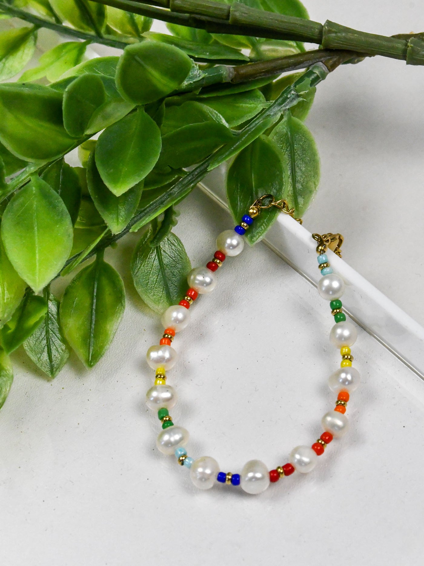 A bracelet with multi colors of beads and pearl beads. 