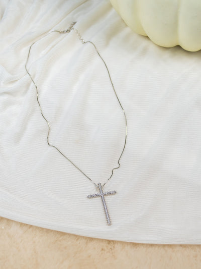 A silver cross necklace with CZ sparkle stones.