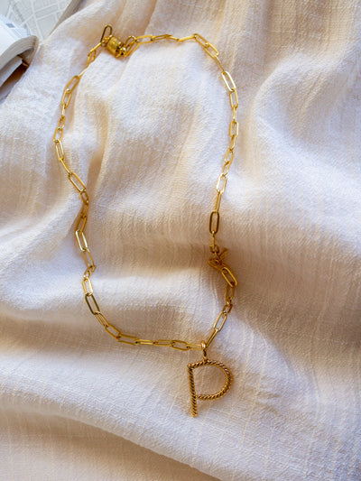 A square link/ paperclip style chain necklace with a twisted capital P attached to it.