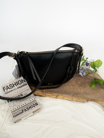 A black vegan leather shoulder bag with a chain strap and two compartments.