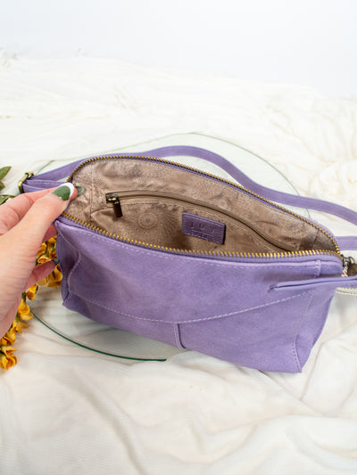 A purple antiqued vegan leather crossbody, clutch, or wristlet style purse.