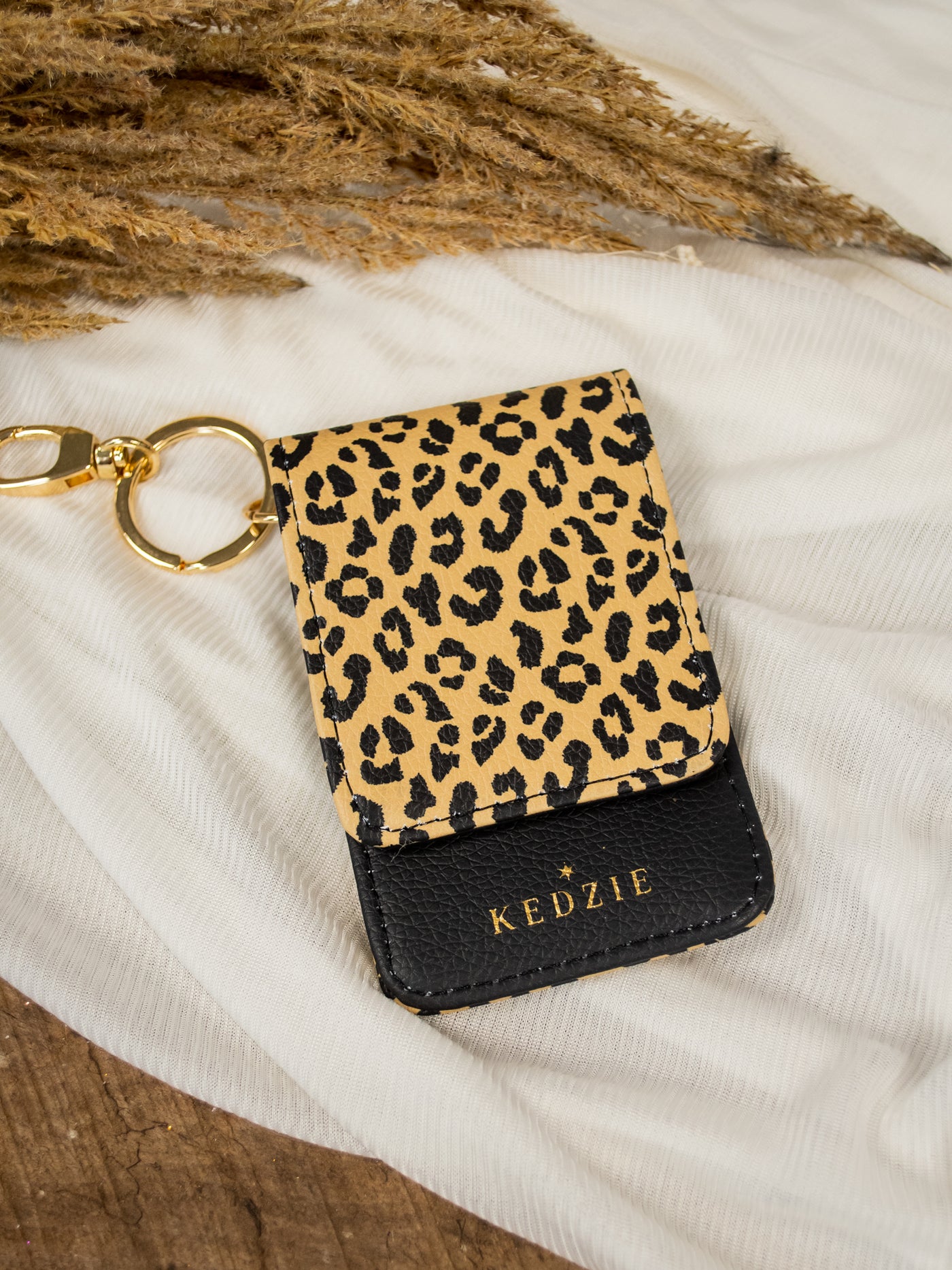 A leopard and black id holder keychain.