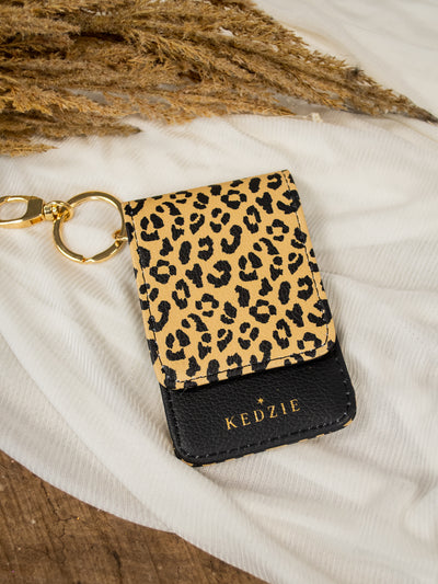 A leopard and black id holder keychain.