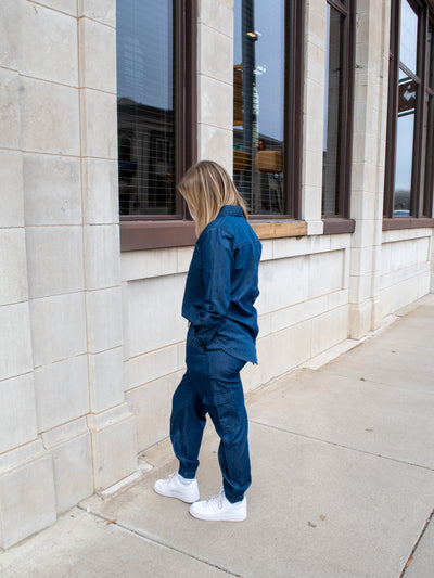 A model wearing a pair of denim like utility joggers with a button down denim shirt. 