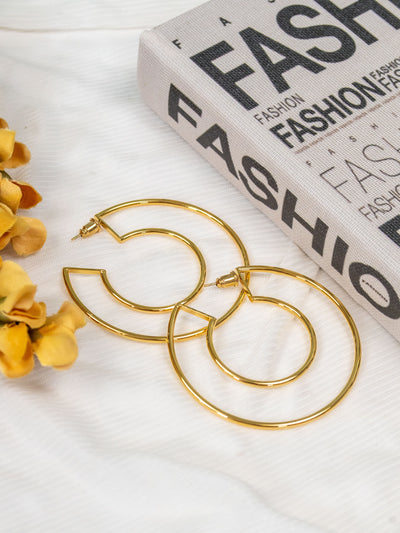A pair of gold cutout hoops.