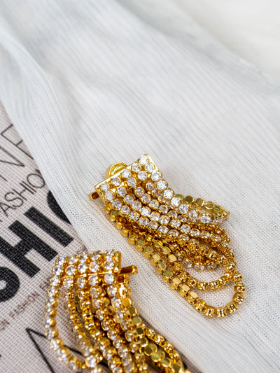 A gold dangly statement earring with cz stones.