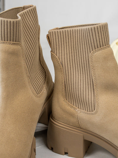 A pair of tan suede and rib-knit, lug sole platform chunky Chelsea booties. 