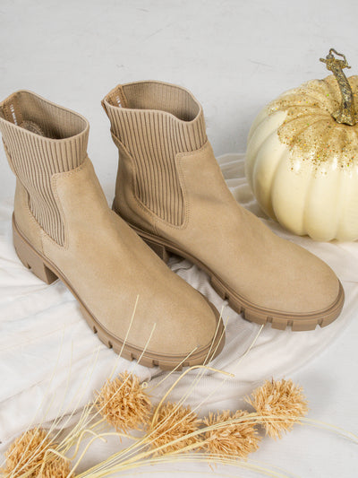 A pair of tan suede and rib-knit, lug sole platform chunky Chelsea booties. 